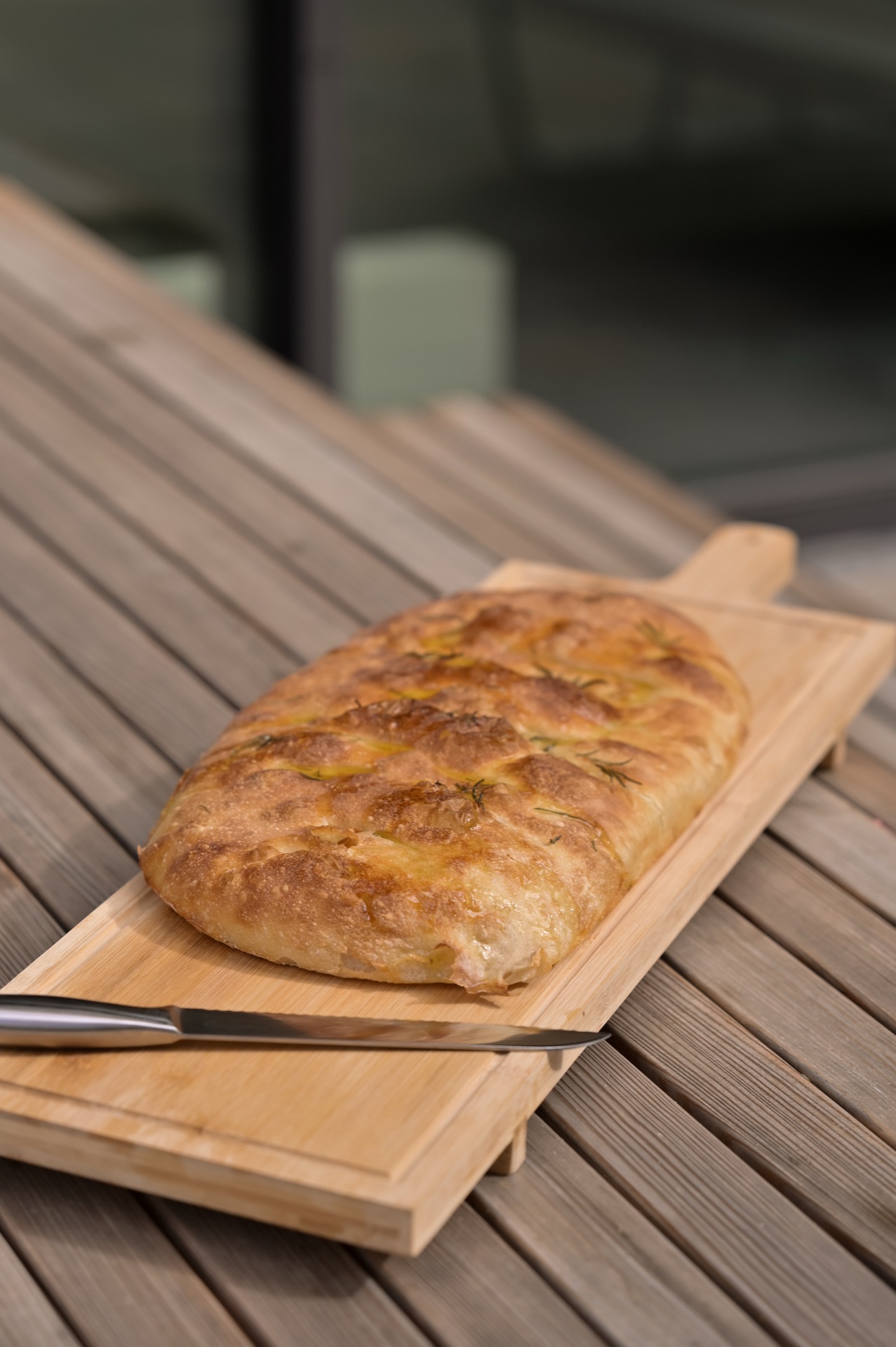 Whole focaccia on cutting board