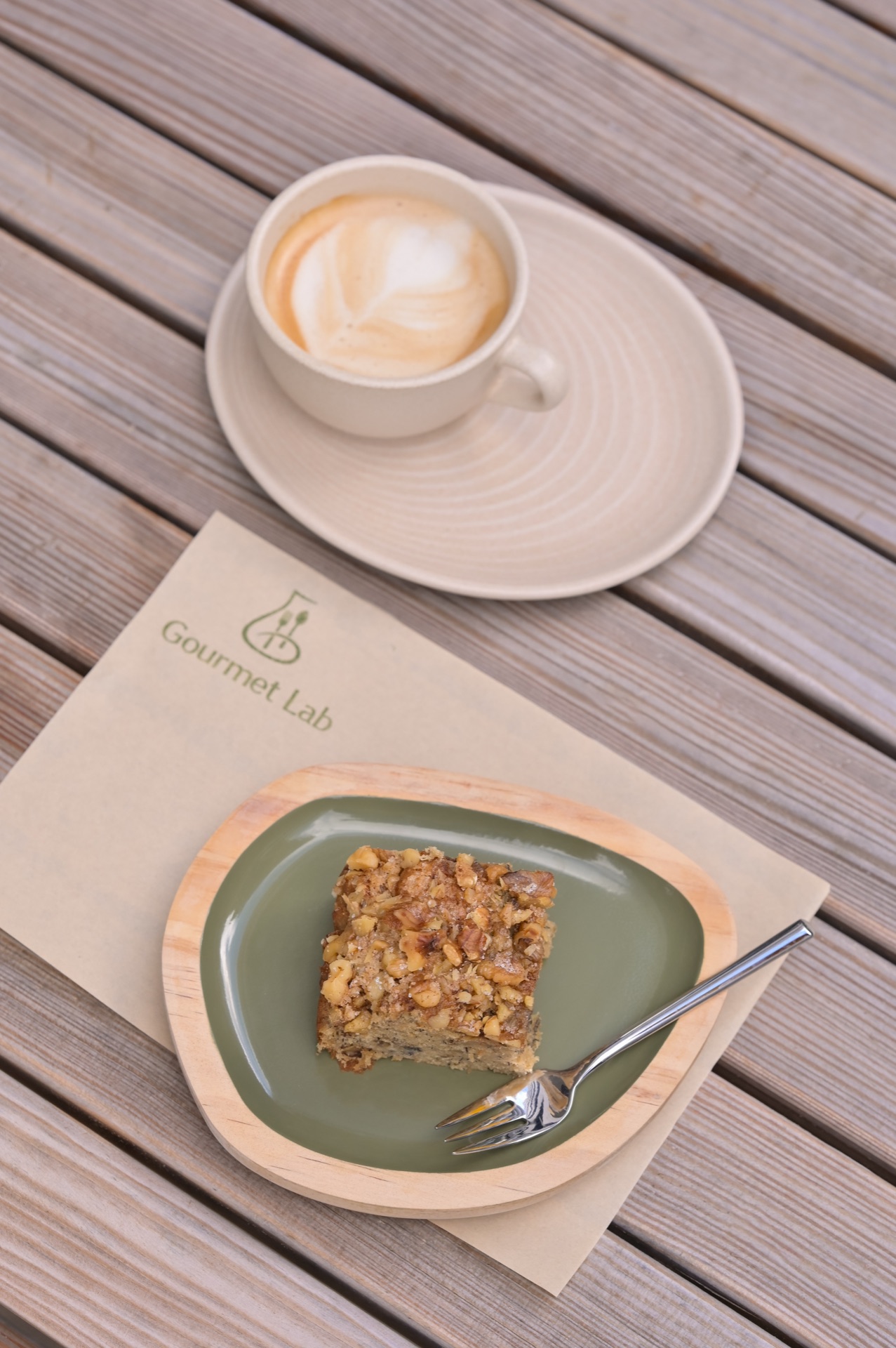 Nut cake with latte on terrace